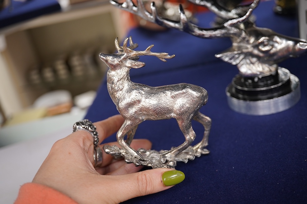 Five chrome and brass car radiator mascots; three in the form of stags’ heads, a stag standing on an oak branch and an Art Deco leading gazelle. Condition - fair, some losses to chrome plating.